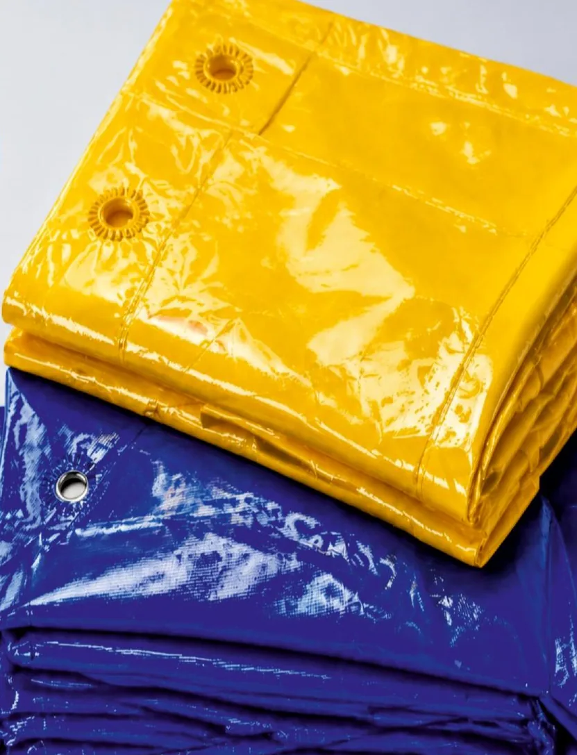 Folded yellow and blue multilayer tarpaulins with metal eyelets
